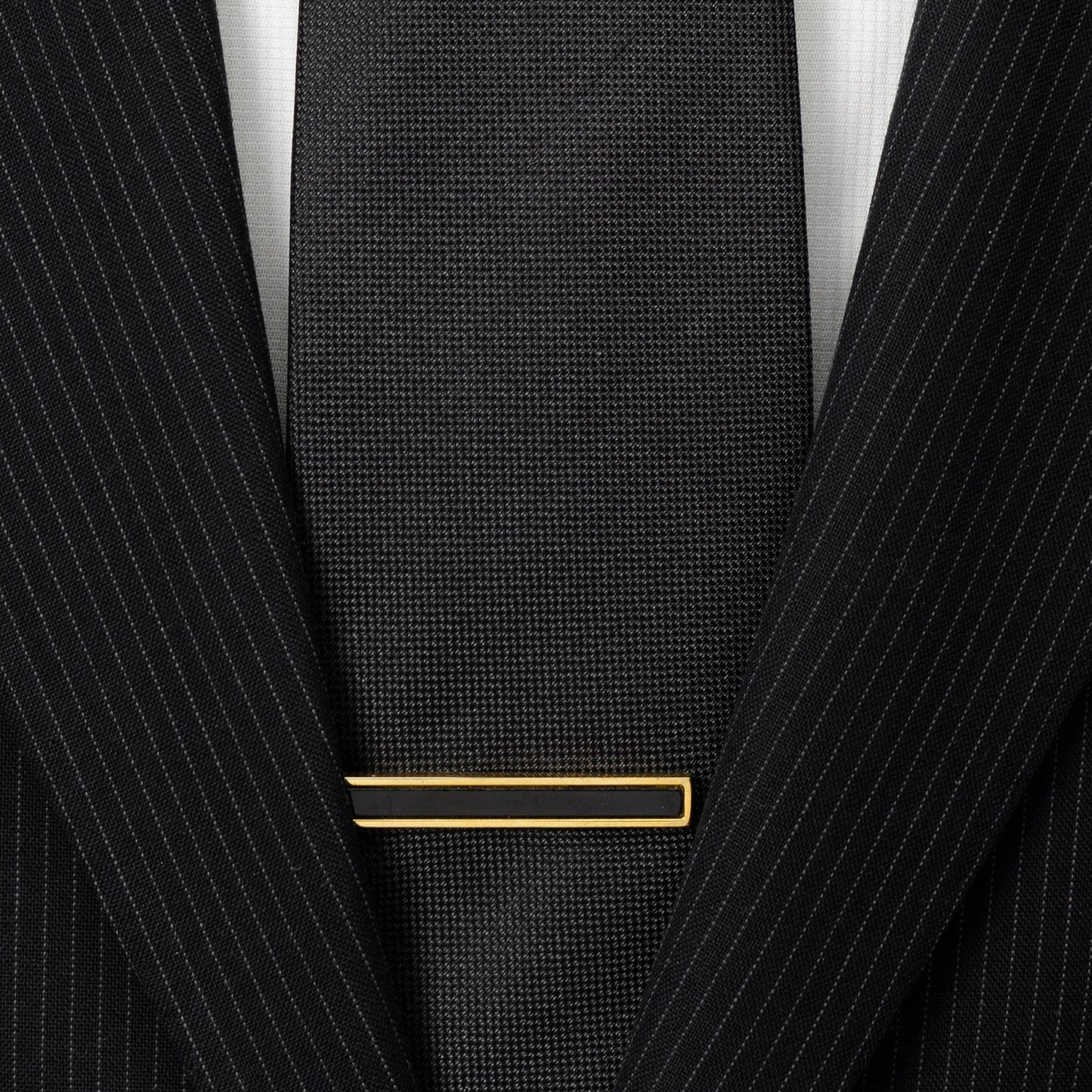 The Gold and Onyx Inlaid Tie Clip by Cufflinks.com, featuring a rectangular black inlay, is displayed against a white background.