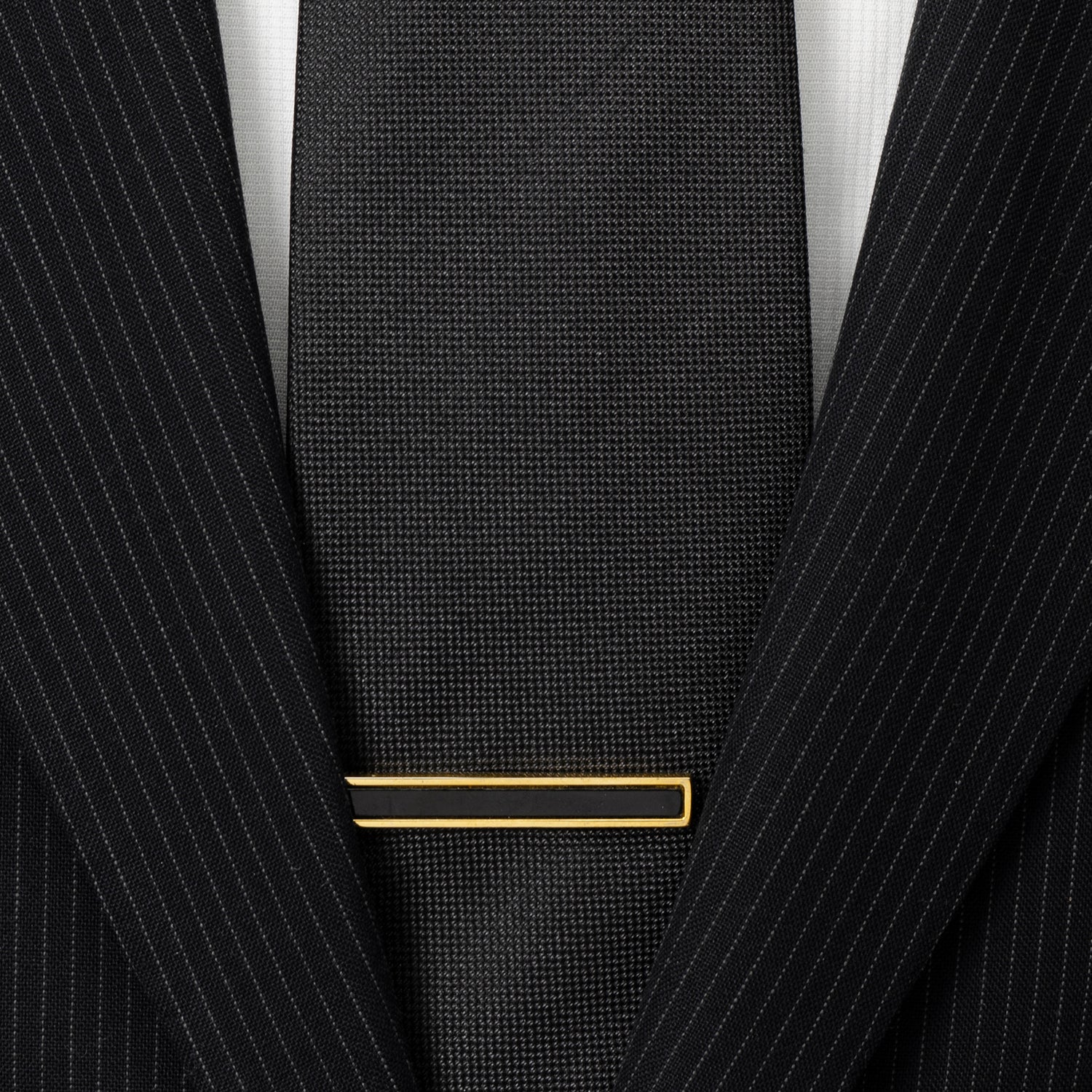 The Gold and Onyx Inlaid Tie Clip by Cufflinks.com, featuring a rectangular black inlay, is displayed against a white background.
