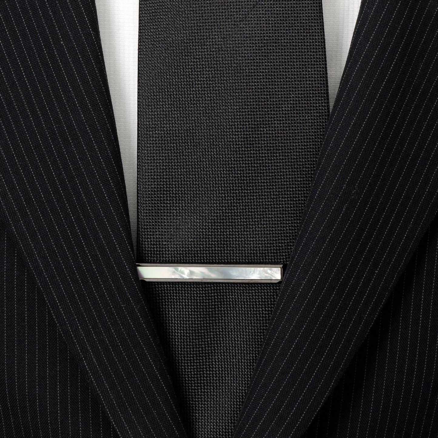 The Cufflinks.com Gunmetal and Mother of Pearl Inlaid Tie Clip features a sleek gunmetal finish with a rectangular iridescent inlay, adding refined style to your accessory collection.