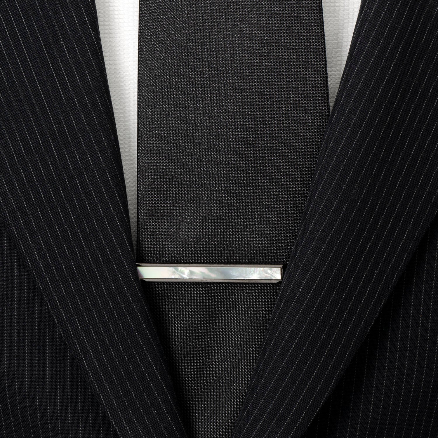 The Cufflinks.com Gunmetal and Mother of Pearl Inlaid Tie Clip features a sleek gunmetal finish with a rectangular iridescent inlay, adding refined style to your accessory collection.