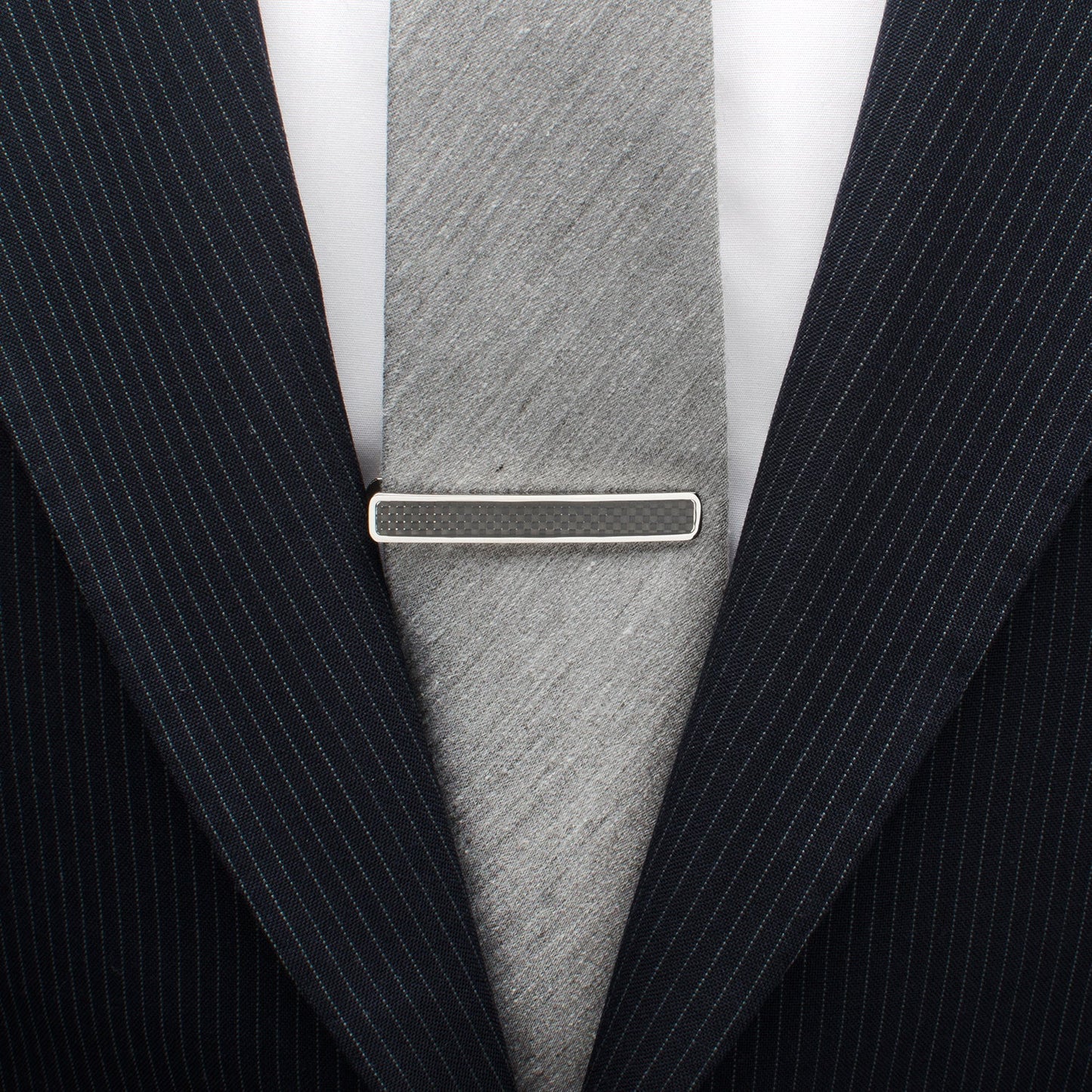 The Cufflinks.com Black Carbon Fiber Stainless Steel Tie Clip features a sleek design with a bold black carbon fiber inlay, displayed on a white background.