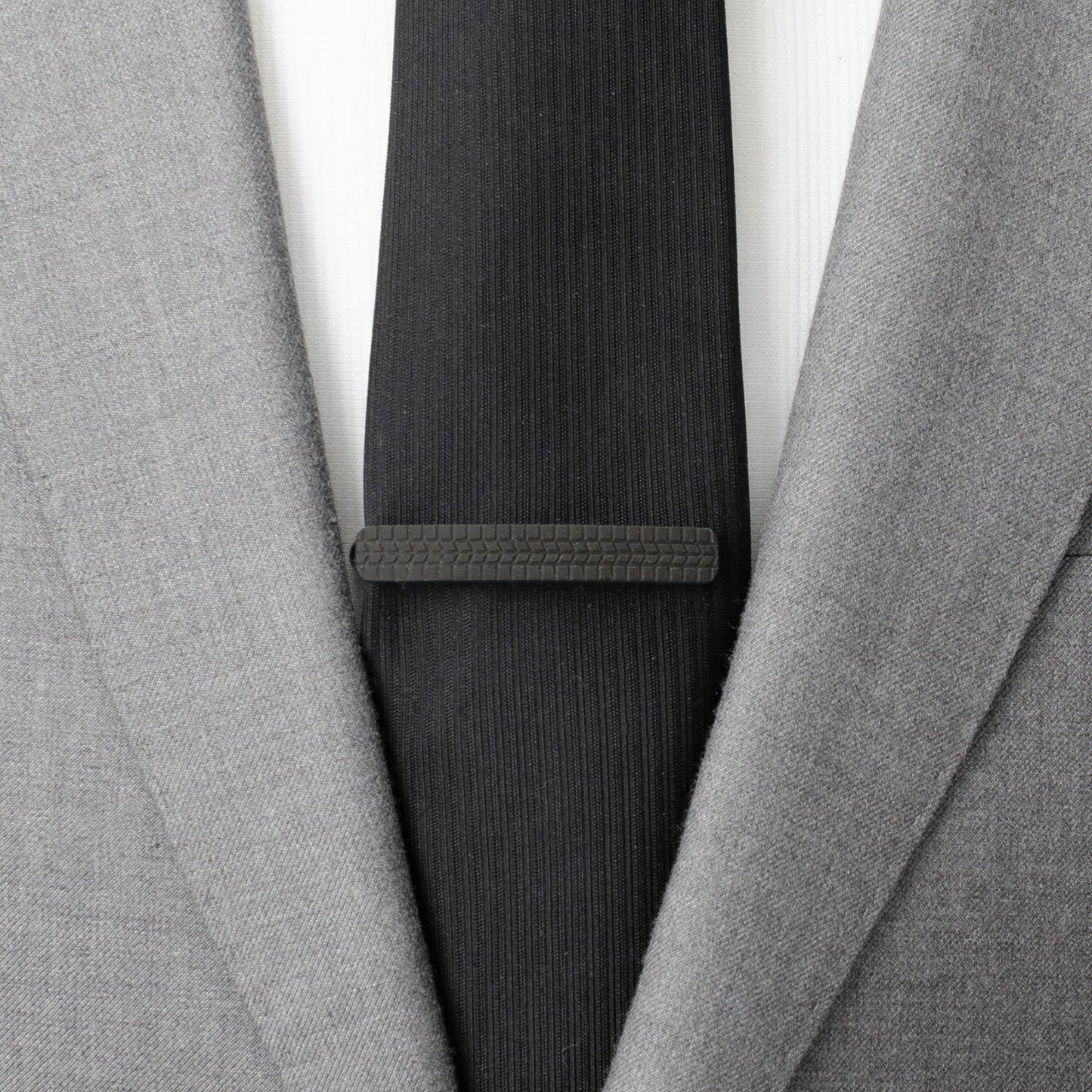 The Cufflinks.com Stainless Steel Carbon Fiber Tire Tread Tie Clip features a black, tire tread-inspired carbon fiber grip on top, displayed against a white background.