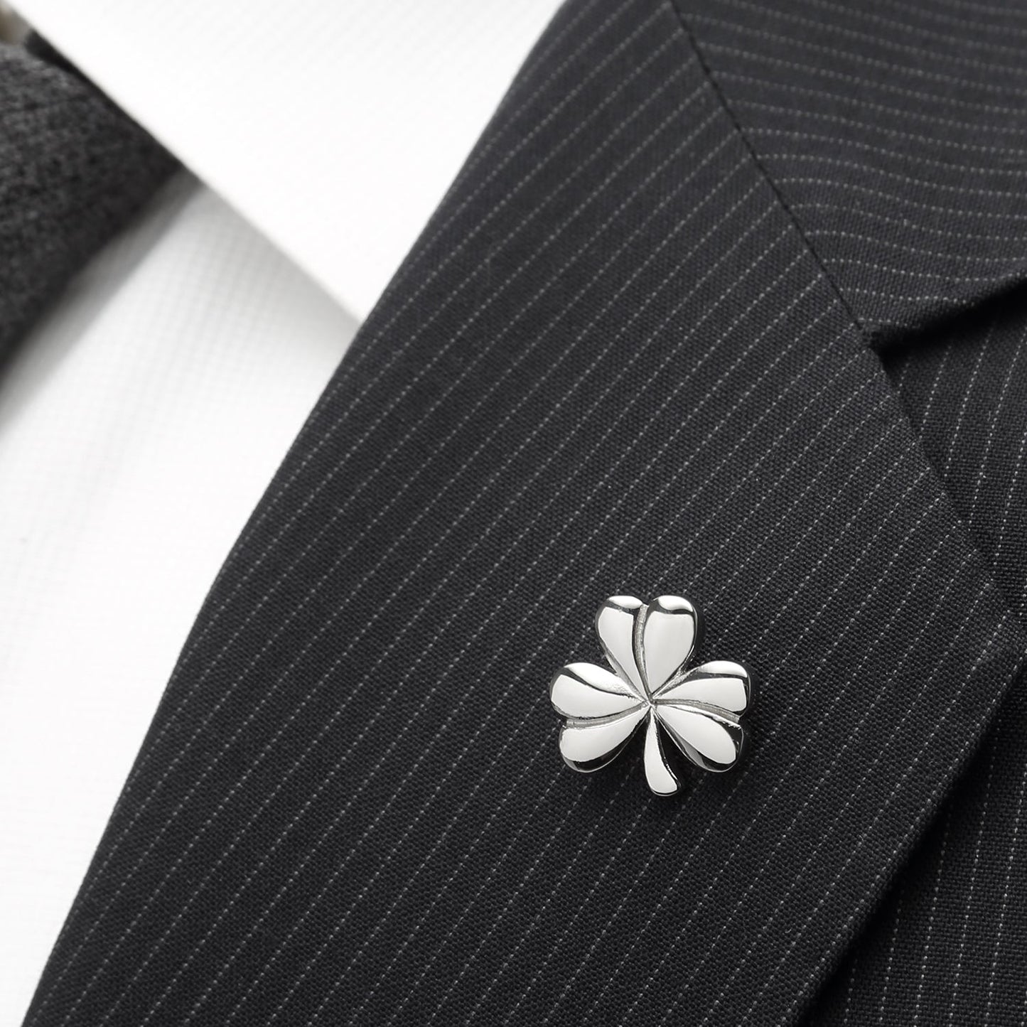 The Clover Stainless Steel Lapel Pin by Cufflinks.com features a polished silver-tone clover design, photographed on a plain white background—a stylish accessory perfect for formal occasions.