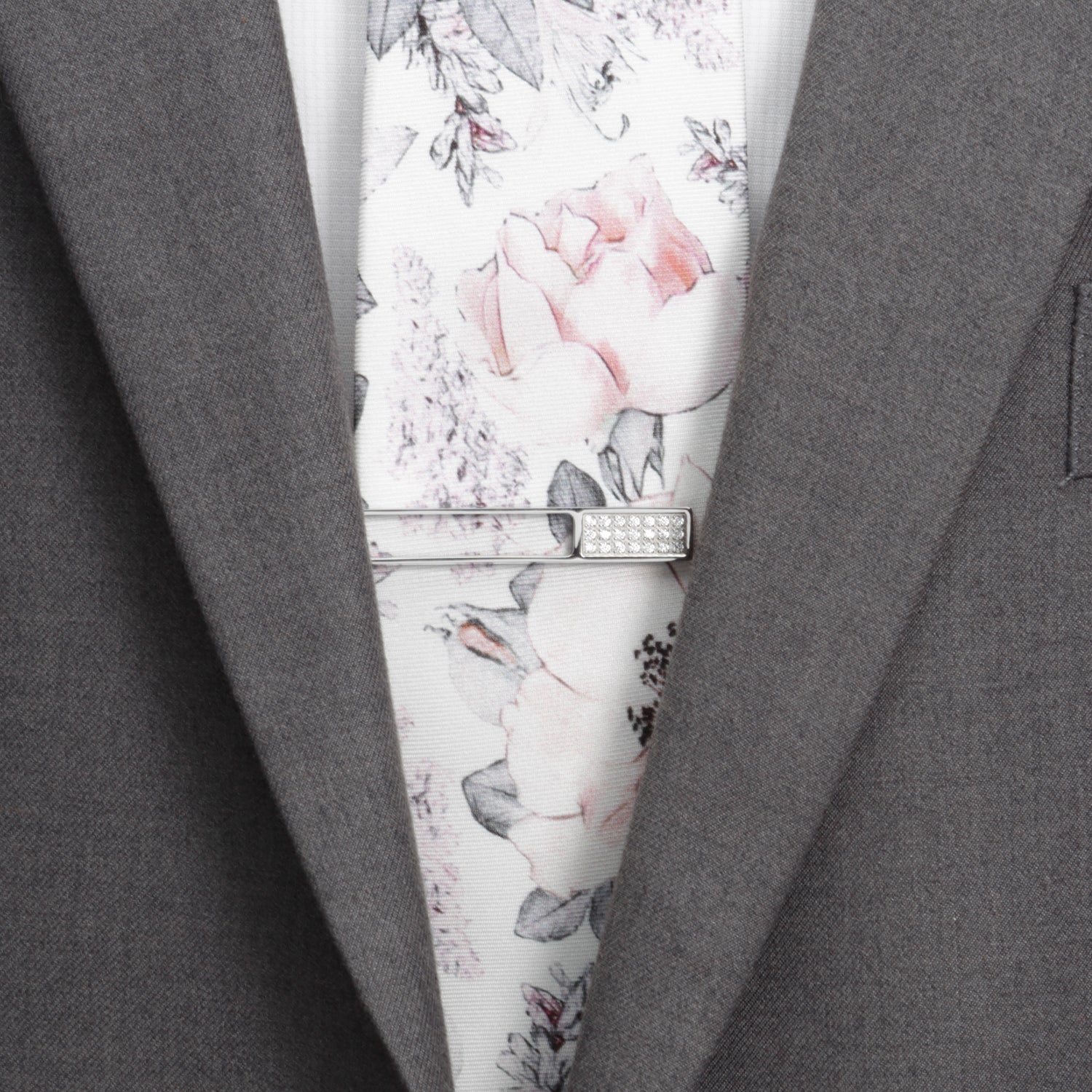 The Die Cut Crystal Stainless Steel Tie Clip by Cufflinks.com features a rectangular cutout design with a row of clear gemstones on one end, crafted from stainless steel and shown on a white background.