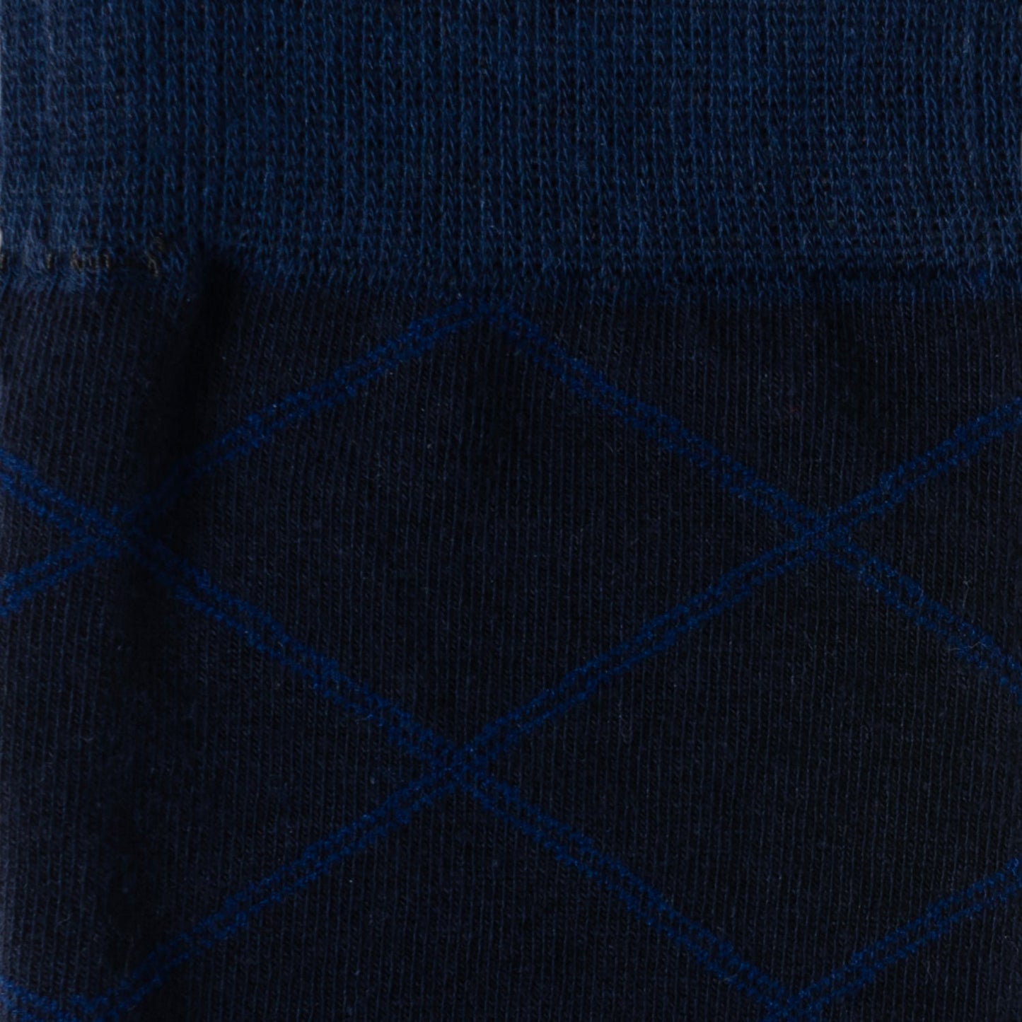 The Grid Navy Men's Sock by Cufflinks.com is crafted from a soft cotton blend, featuring a subtle light blue diamond grid pattern, and is shown against a white background.