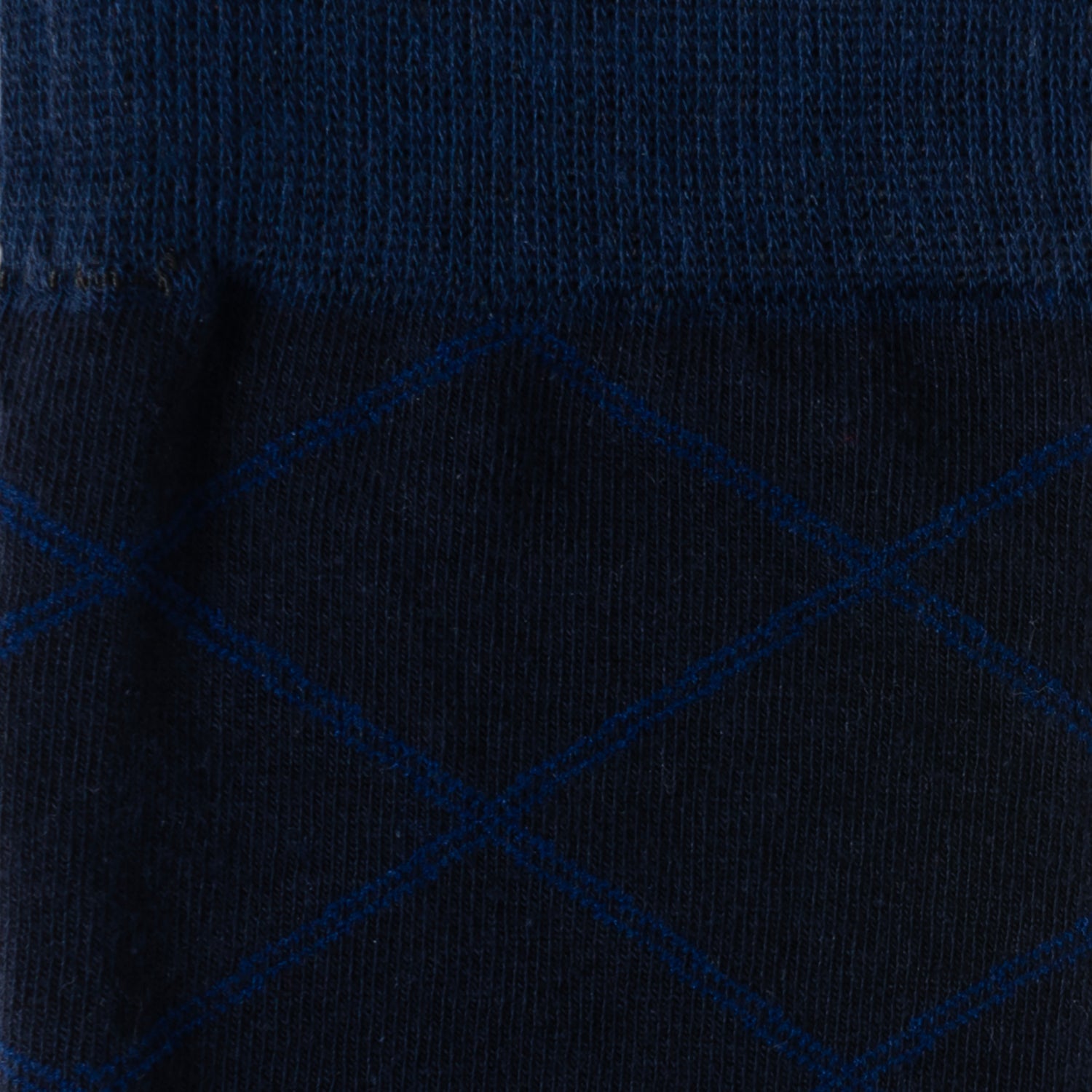 The Grid Navy Men's Sock by Cufflinks.com is crafted from a soft cotton blend, featuring a subtle light blue diamond grid pattern, and is shown against a white background.