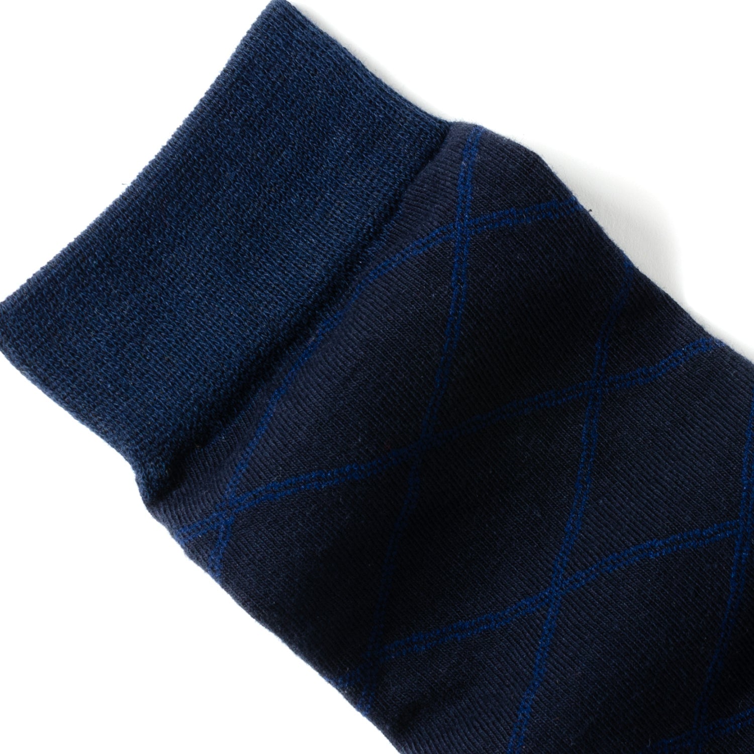 The Grid Navy Men's Sock by Cufflinks.com is crafted from a soft cotton blend, featuring a subtle light blue diamond grid pattern, and is shown against a white background.