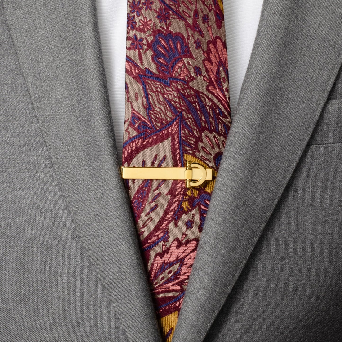 The Horse Bit Gold Stainless Steel Tie Bar from Cufflinks.com features a polished gold finish and decorative clasp, offering a refined men’s accessory inspired by classic horse bit design.
