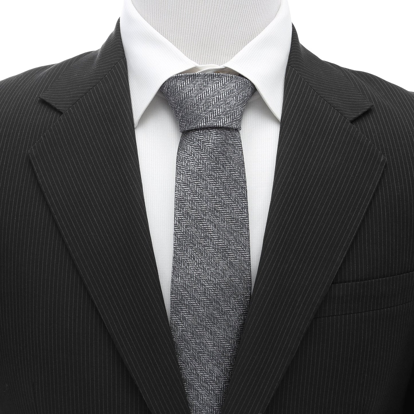 The Herringbone Men's Tie by Cufflinks.com features a rolled-up gray silk design with a classic herringbone stitch pattern on a white background.