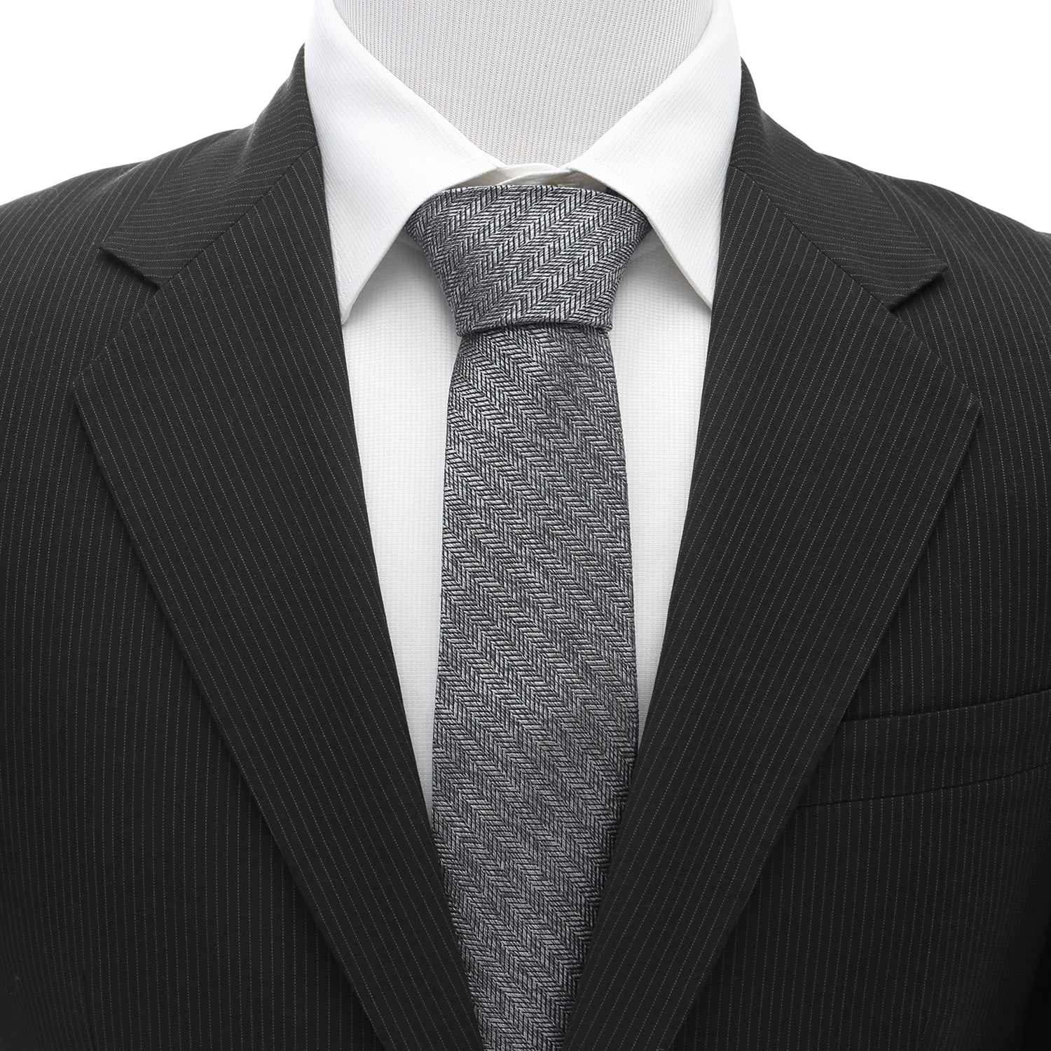 The Herringbone Men's Tie by Cufflinks.com features a rolled-up gray silk design with a classic herringbone stitch pattern on a white background.