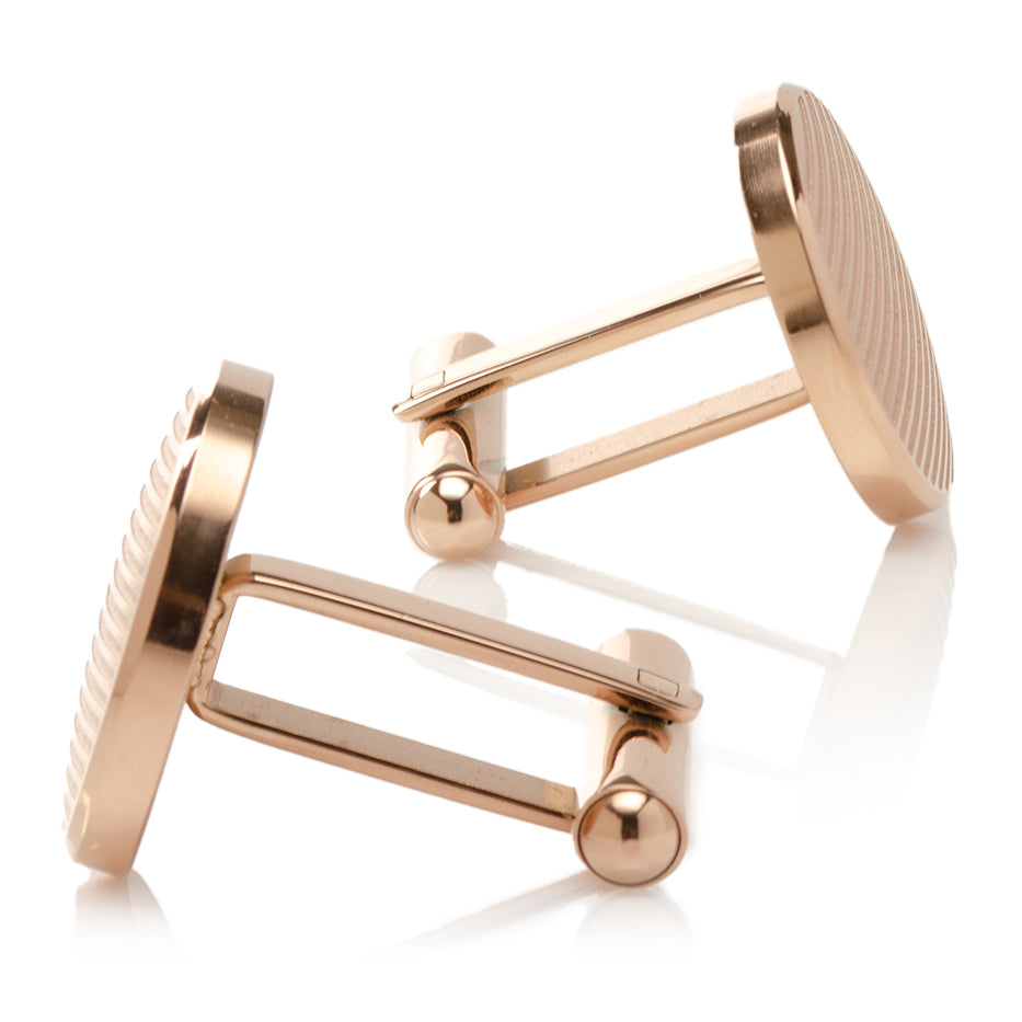 Rose Gold Line Stainless Steel Cufflinks by Cufflinks.com feature a round face with diagonal stripes, showcased against a white background—an elegant addition to men’s accessories.