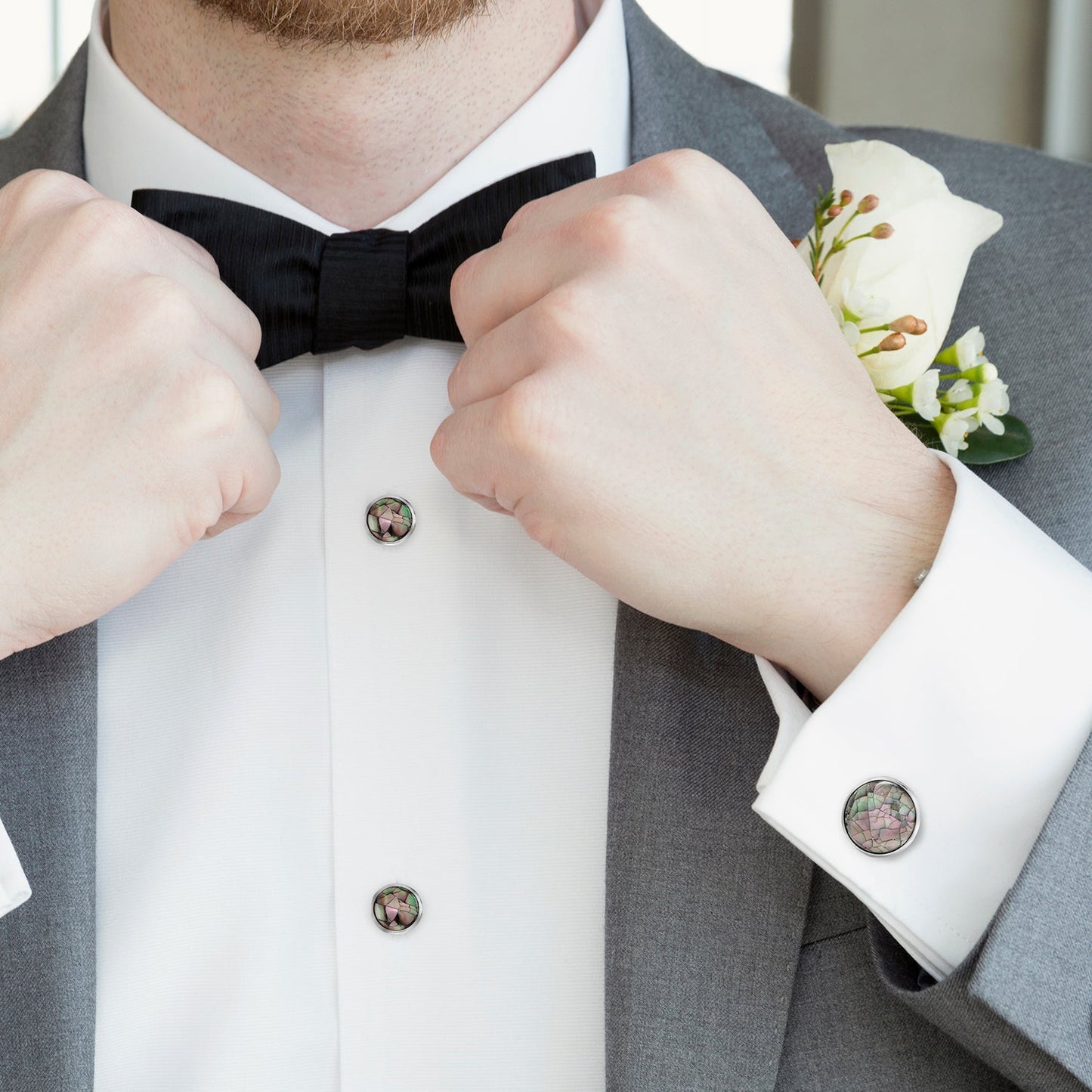 The Mosaic Smoke Mother of Pearl 5-Stud Set by Cufflinks.com features round, iridescent shell inlays that create a striking mosaic pattern on cufflinks and silver studs.