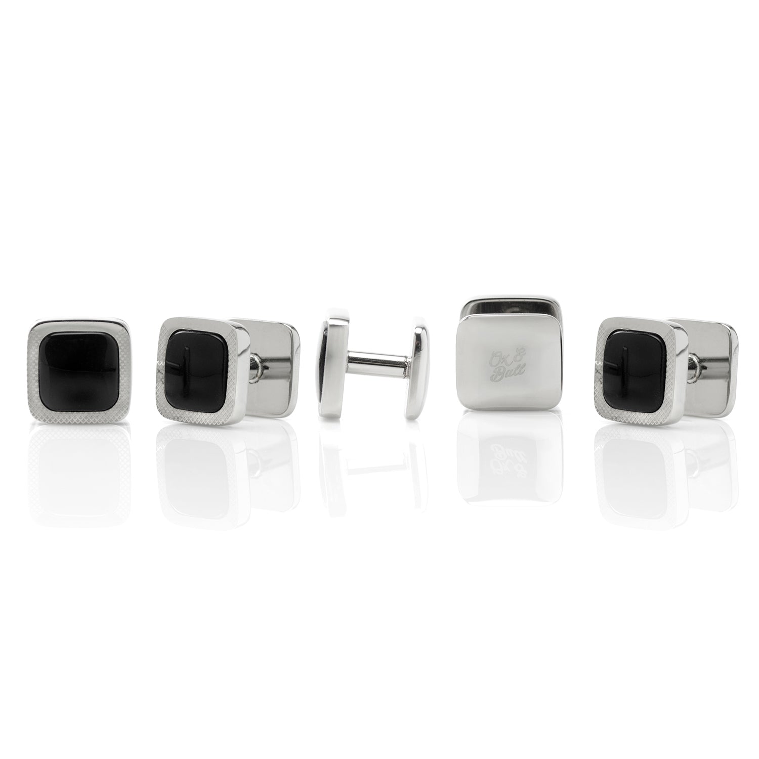 The Onyx Cushion Stainless Steel 5-Stud Set by Cufflinks.com features silver cufflinks and stainless steel studs with black square centers, shown on a white background.
