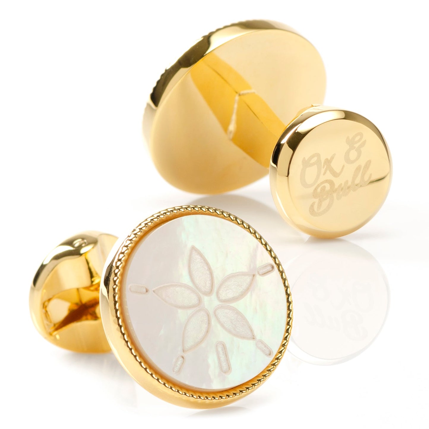 The Sand Dollar Cufflinks by Cufflinks.com feature round mother-of-pearl faces, each intricately engraved with a sand dollar design.