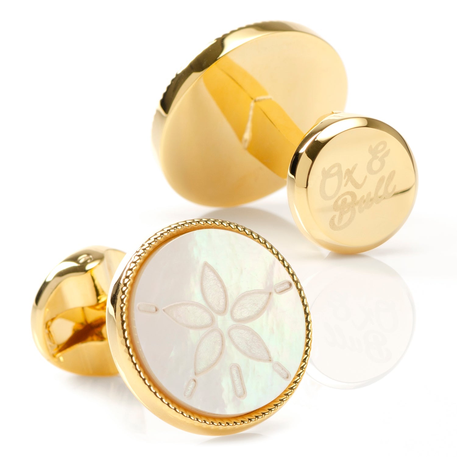 The Sand Dollar Cufflinks by Cufflinks.com feature round mother-of-pearl faces, each intricately engraved with a sand dollar design.