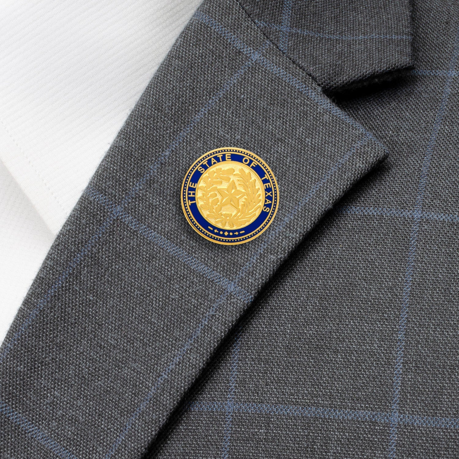 The State of Texas Seal Lapel Pin by Cufflinks.com is gold plated with a blue border, displaying “The State of Texas” and a central star framed by laurel and oak branches—a classic accessory for any Texan.