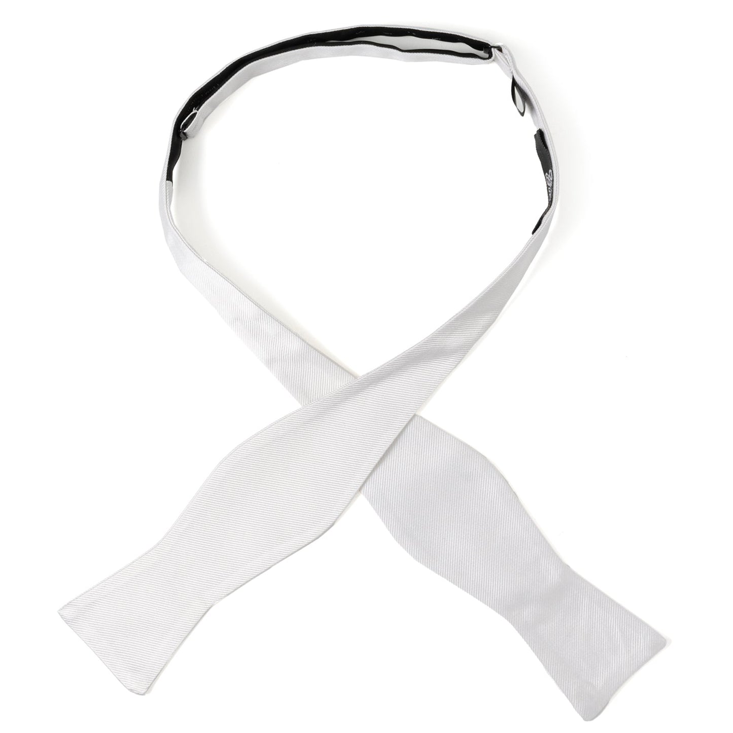 The White Silk Self Bow Tie by Cufflinks.com features ribbed silk fabric, an adjustable strap, and is shown tied and untied.