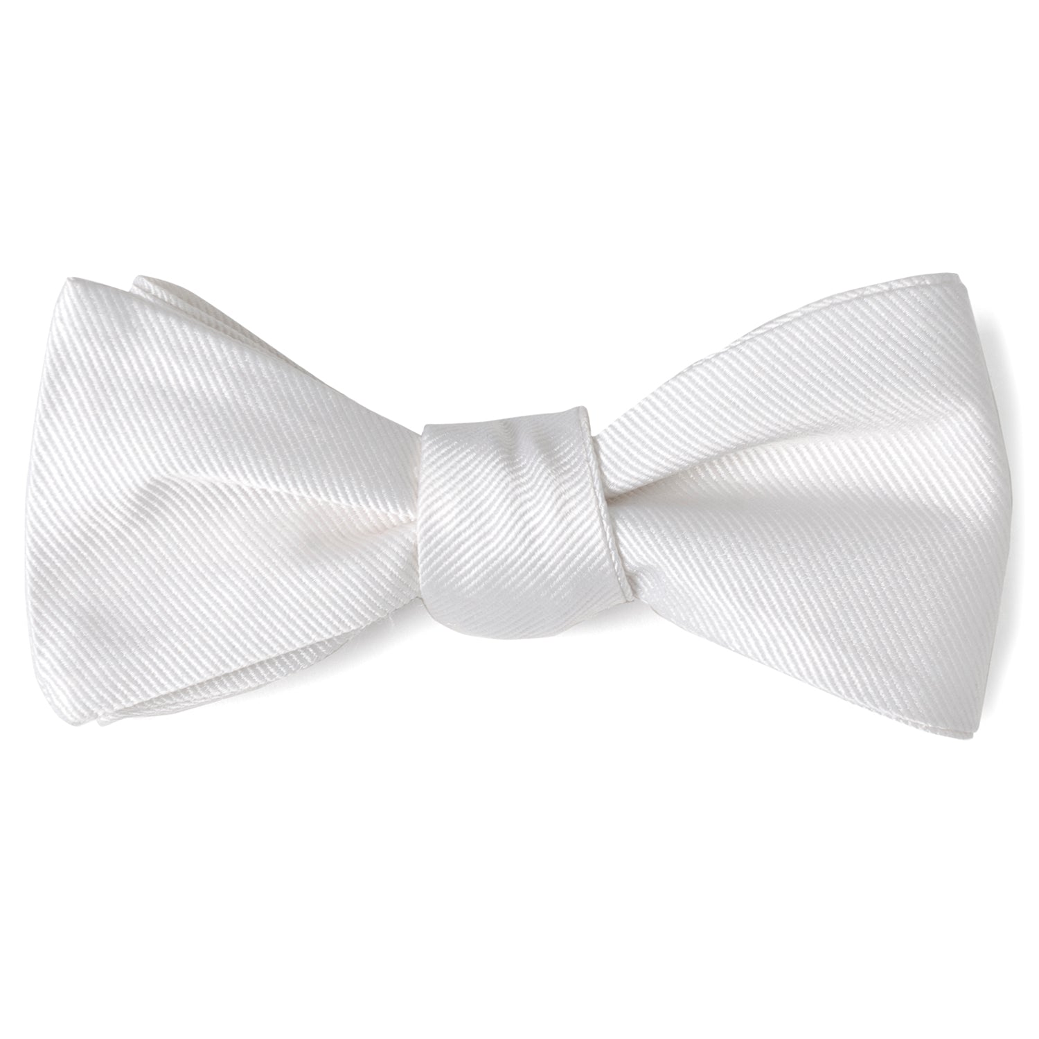 The White Silk Self Bow Tie by Cufflinks.com features ribbed silk fabric, an adjustable strap, and is shown tied and untied.