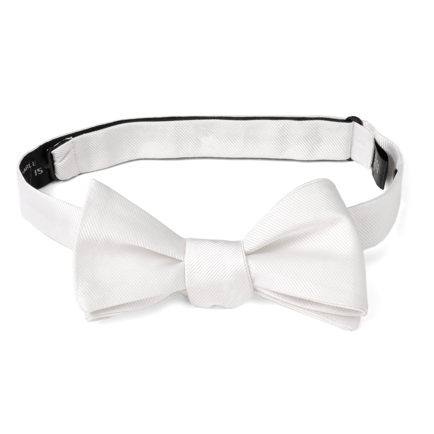 The White Silk Self Bow Tie by Cufflinks.com features ribbed silk fabric, an adjustable strap, and is shown tied and untied.