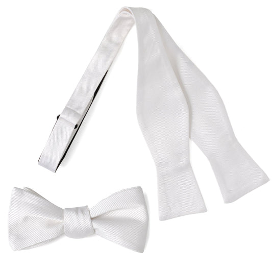 The White Silk Self Bow Tie by Cufflinks.com features ribbed silk fabric, an adjustable strap, and is shown tied and untied.
