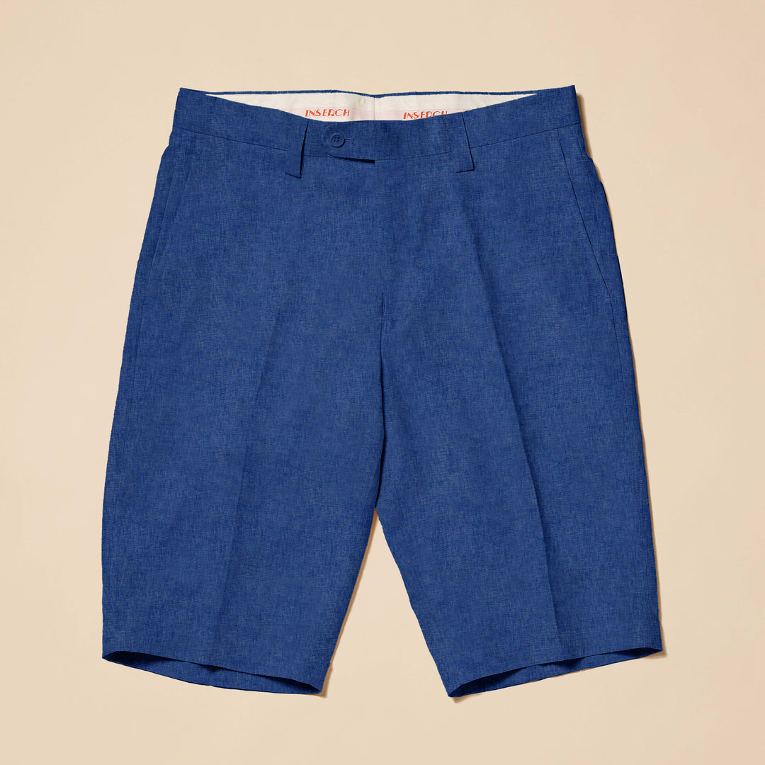 Inserch Premium Linen Flat Front Shorts P21116-00190 in Estate Blue, knee-length with button and zip closure, lay flat on a beige surface.