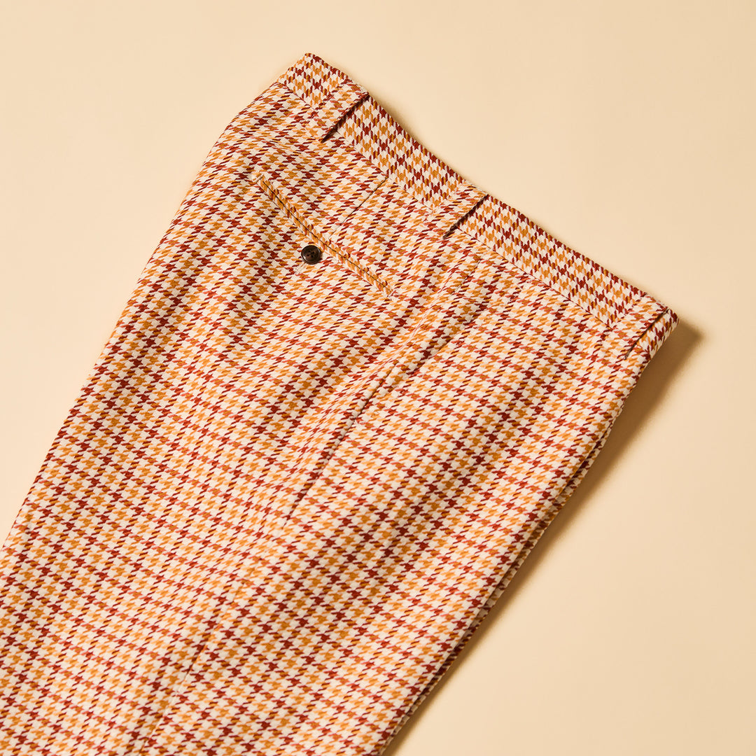 The Inserch Houndstooth Pants P279-00035 Rust by Inserch feature a red and yellow houndstooth pattern on beige, with an 8.5" leg opening and a 34" inseam for a great fit.