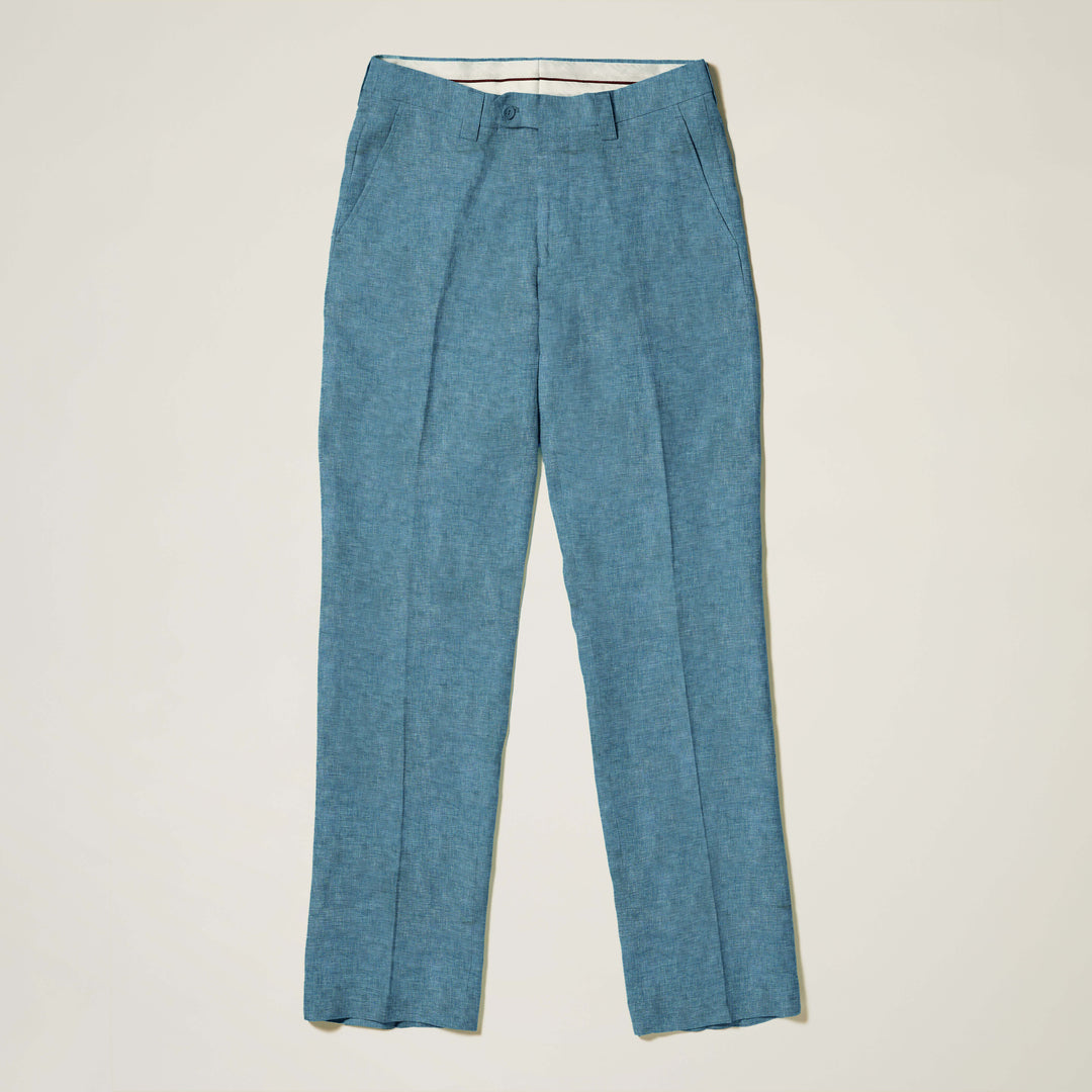 A man stands against a beige backdrop wearing the Inserch Linen 2pc Set (Shirts and Pants) SS717 in Caspian blue by Inserch, with one hand in his pocket.