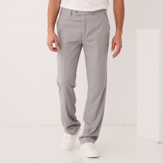 A model wears Inserch Crepe Flat Front Pants P3156-00033 Grey with a white shirt, shown waist to mid-thigh, one hand in the pocket. The poly-crepe fabric is machine washable cold for easy care by Inserch.