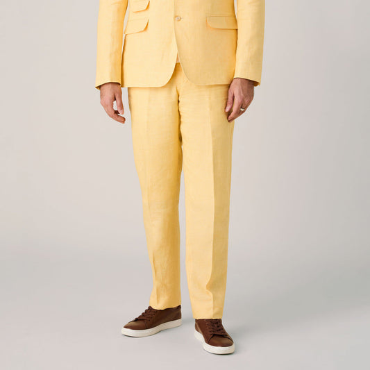 A person stands against a neutral background wearing Inserch Linen Pants P31-00055 Yuzu, tailored from premium European flax for refined comfort. Paired with brown sneakers, the image shows only the body—no head is visible.