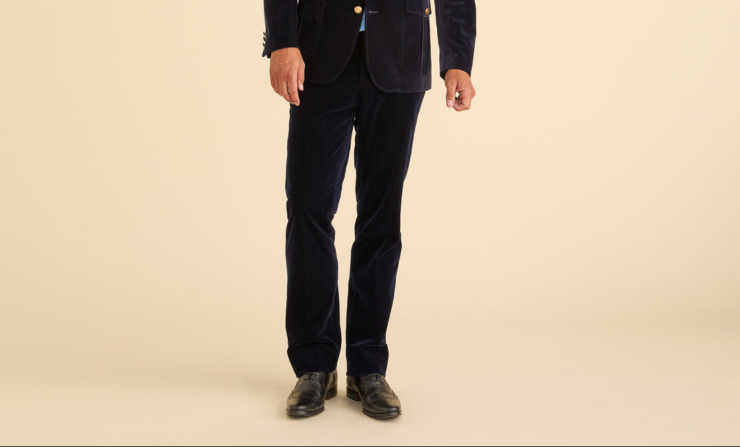Person wearing a navy suit on a beige background