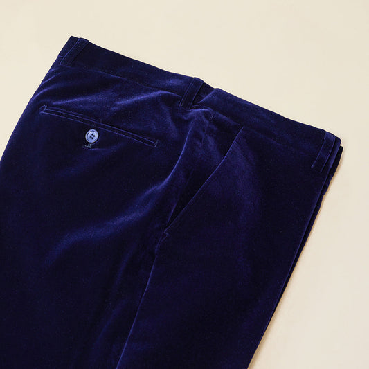 The Inserch Velvet Pants P502-13 in royal blue feature a modern fit with visible back pocket and button, neatly folded and displayed on a light surface.