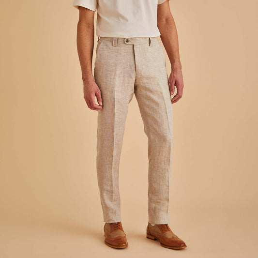 A person wearing a white short-sleeve shirt, Inserch Slim Linen Pants P880-00048 Natural by Inserch, and brown dress shoes stands against a plain beige background.