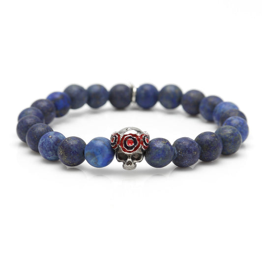 The Gothic Skull Pop Rubber Bracelet Navy 39cm by Cufflinks.com features dark blue beads and a silver skull bead with red accents, finished with a unique clasp for standout style.