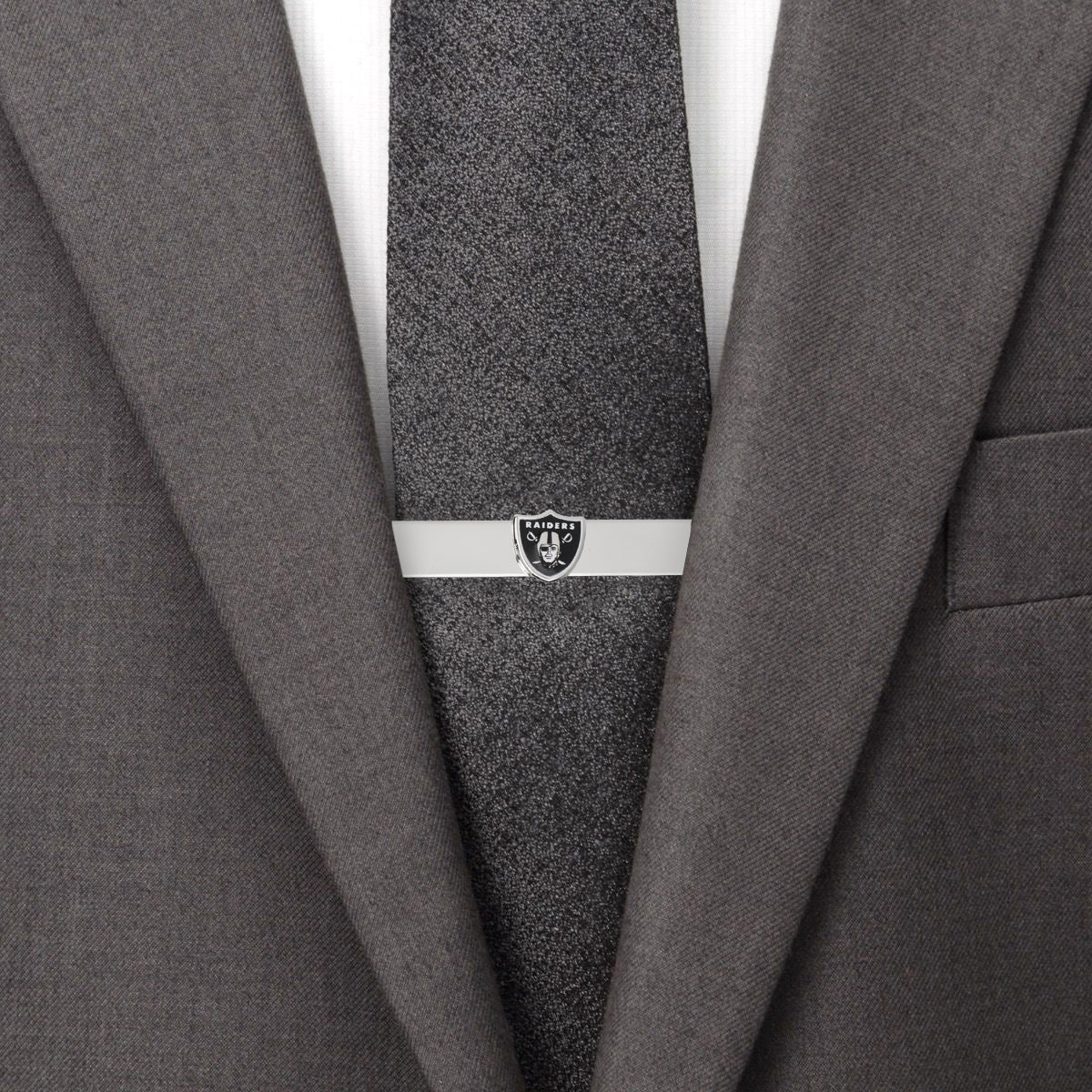 Display your team spirit with the NFL Las Vegas Raiders Cufflinks and Tie Bar Gift Set by Cufflinks.com, featuring the iconic shield, helmeted figure, and crossed swords in black and silver.