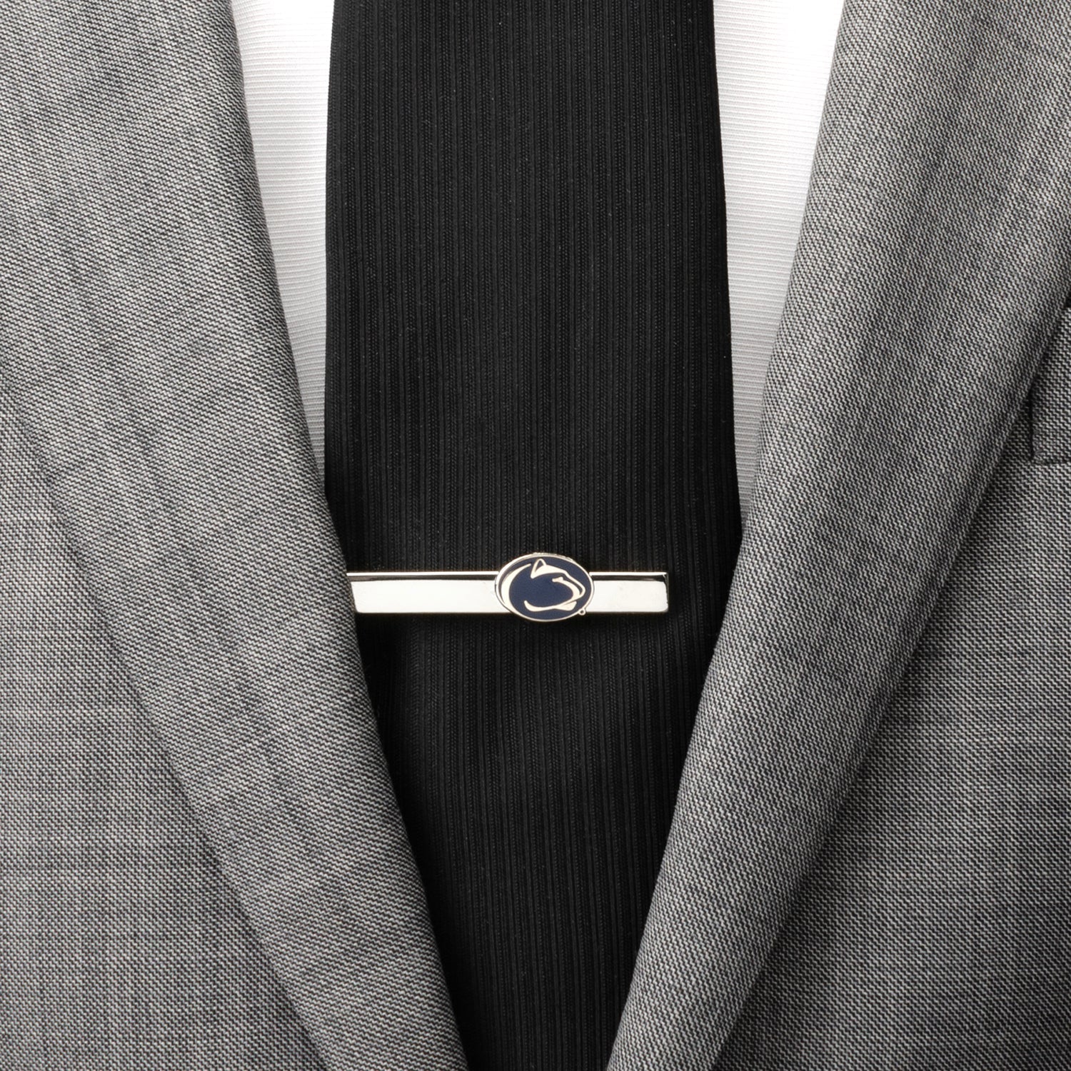 The NCAA Penn State University Cufflinks and Tie Clip Gift Set by Cufflinks.com features silver accessories with a navy emblem and white Nittany Lion head—perfect for any fan or alum.