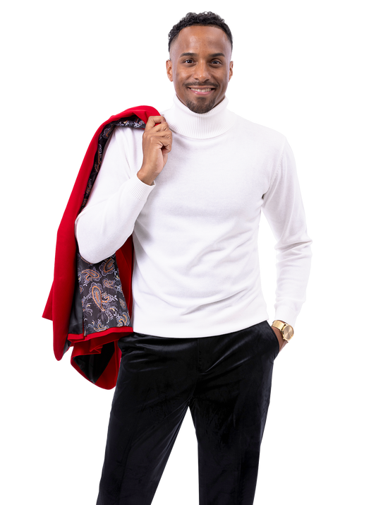 A man wearing EJ Samuel Black Pants PV01 is dressed in a white turtleneck and carries a red jacket with a patterned lining over his shoulder.