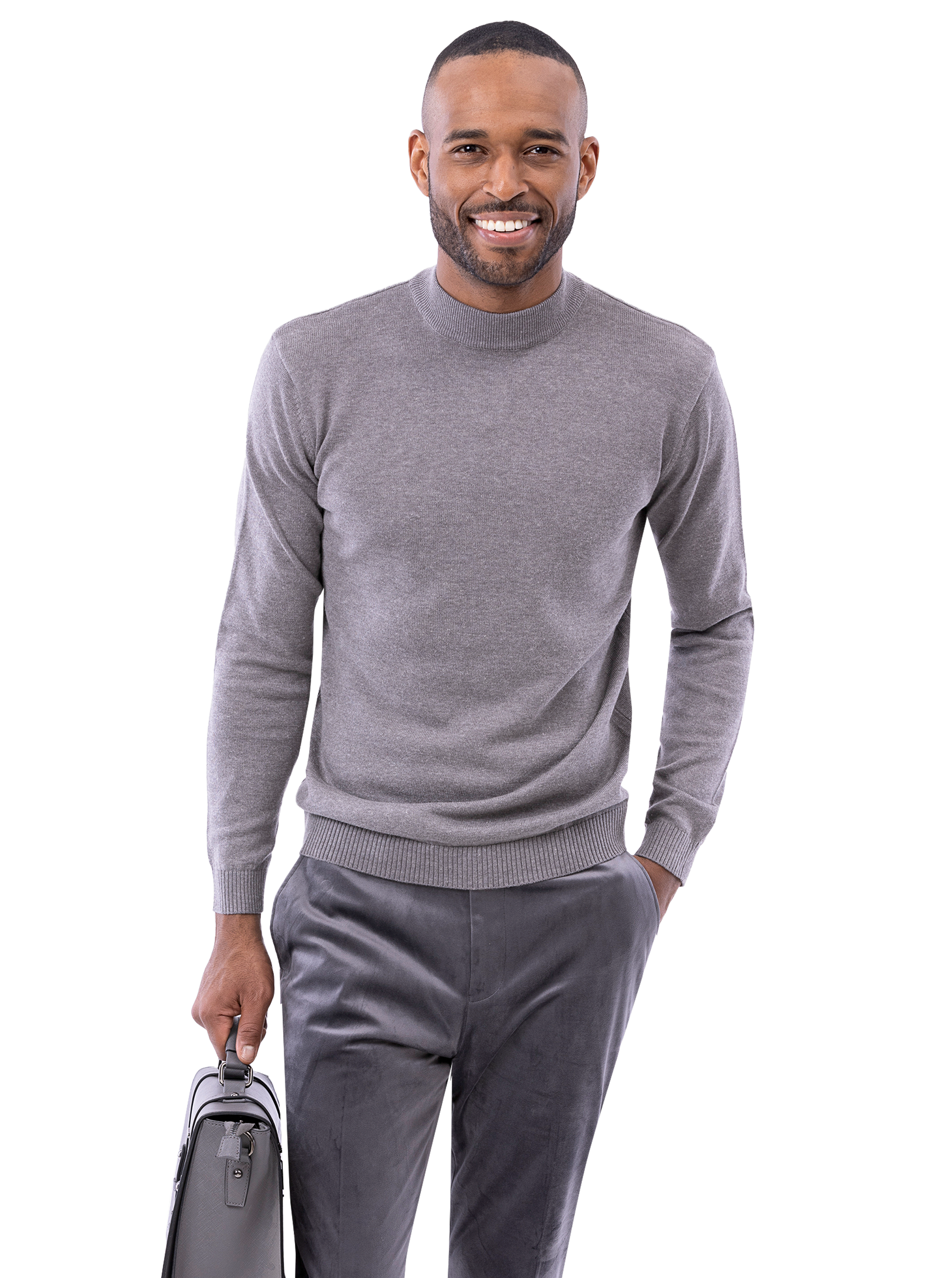 A person in a gray sweater and EJ Samuel Charcoal Pants PV01 holds a briefcase and smiles.