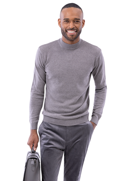 A person in a gray sweater and EJ Samuel Charcoal Pants PV01 holds a briefcase and smiles.