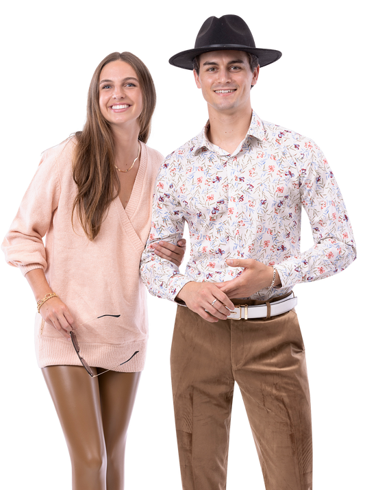 A woman in a peach sweater and a man wearing a hat, floral shirt, and EJ Samuel Taupe Pants PV01 stand smiling side by side.