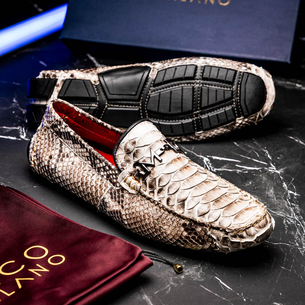 Pair of Marco Di Milano’s Pia Natural men’s loafers, crafted from exotic python skin leather and featuring a sleek metal buckle detail, displayed against a white background. One luxury loafer stands upright while the other is tilted to reveal the sole, showcasing the refined craftsmanship of these signature driver shoes.