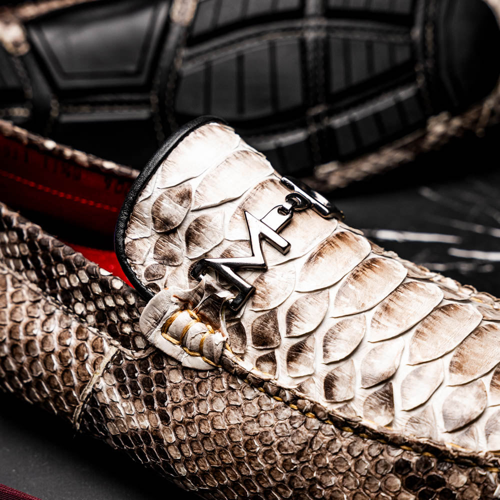 Pair of Marco Di Milano’s Pia Natural men’s loafers, crafted from exotic python skin leather and featuring a sleek metal buckle detail, displayed against a white background. One luxury loafer stands upright while the other is tilted to reveal the sole, showcasing the refined craftsmanship of these signature driver shoes.