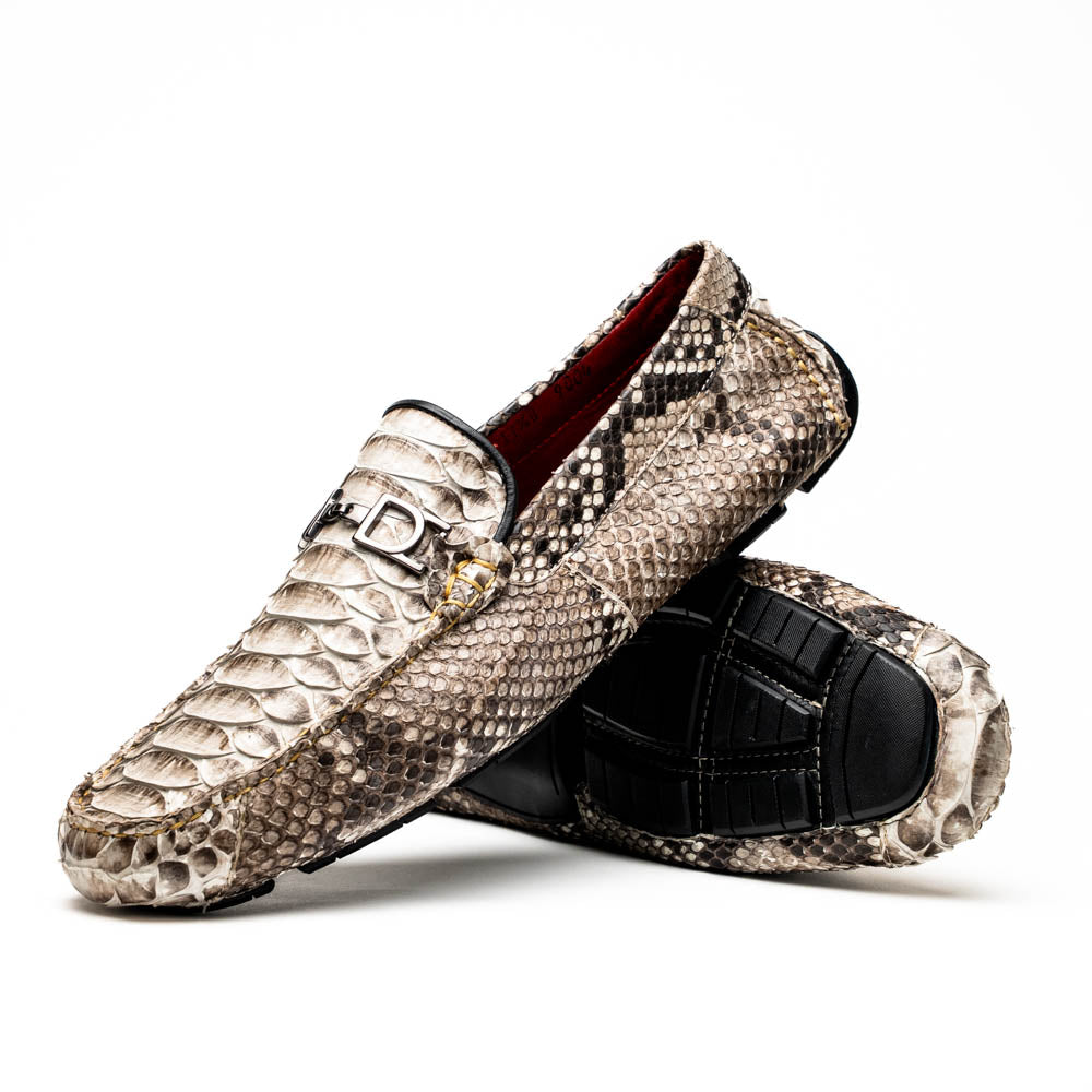 Pair of Marco Di Milano’s Pia Natural men’s loafers, crafted from exotic python skin leather and featuring a sleek metal buckle detail, displayed against a white background. One luxury loafer stands upright while the other is tilted to reveal the sole, showcasing the refined craftsmanship of these signature driver shoes.