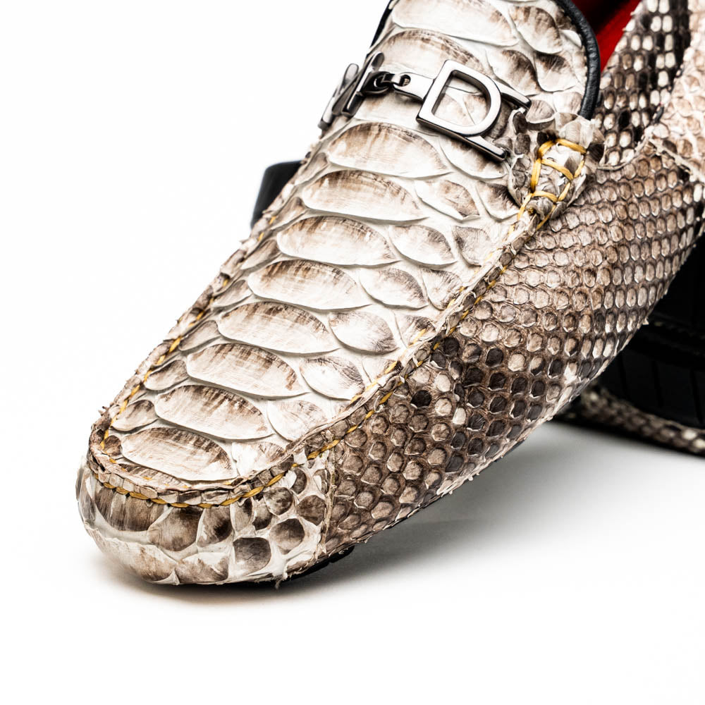 Pair of Marco Di Milano’s Pia Natural men’s loafers, crafted from exotic python skin leather and featuring a sleek metal buckle detail, displayed against a white background. One luxury loafer stands upright while the other is tilted to reveal the sole, showcasing the refined craftsmanship of these signature driver shoes.