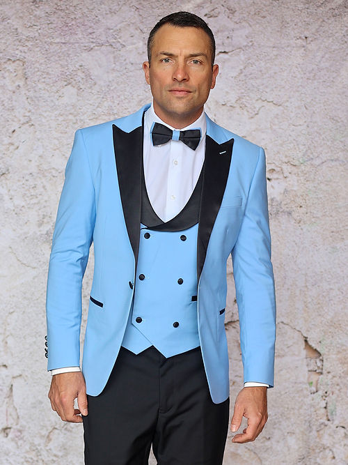 A man in an Insomnia MANZINI ROME Slim Fit 3-Piece Stretch Spandex Sky Tuxedo Suit with a black lapel and bow tie stands against a textured light background.