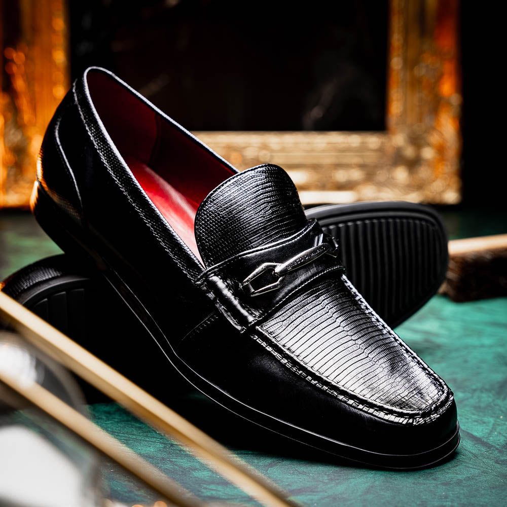 The Ravello Black by Marco Di Milano is a pair of black leather loafers with metal accents, textured uppers, a red interior lining, and ribbed rubber soles—making an exquisite statement in luxury footwear.