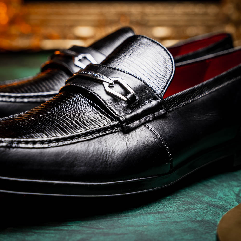 The Ravello Black by Marco Di Milano is a pair of black leather loafers with metal accents, textured uppers, a red interior lining, and ribbed rubber soles—making an exquisite statement in luxury footwear.