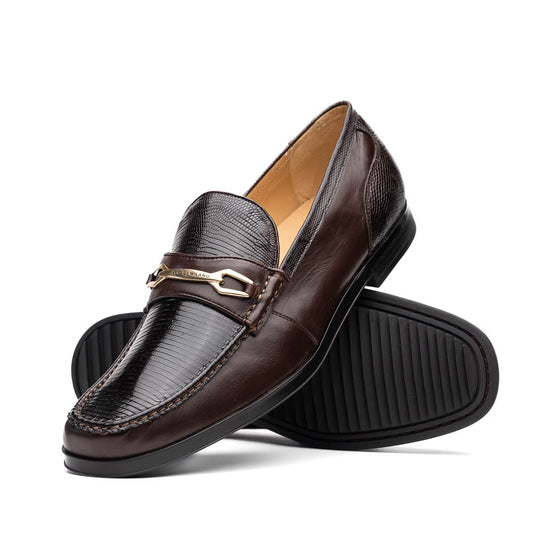 The Marco Di Milano Ravello Brown loafers, crafted from genuine lizard with a metal buckle, are showcased with one shoe upright and the other on its side to highlight the elegant hand-painted finish.