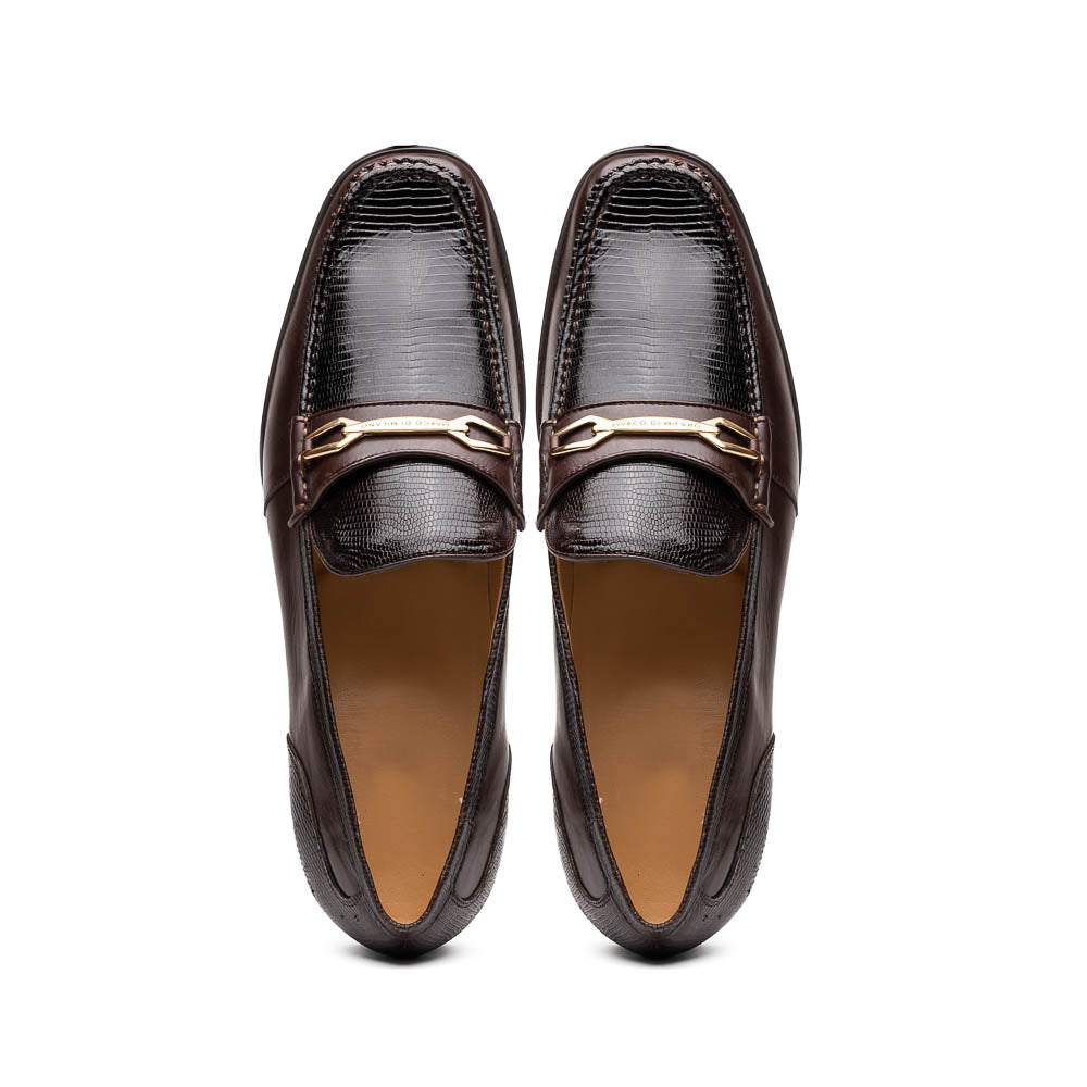 The Marco Di Milano Ravello Brown loafers, crafted from genuine lizard with a metal buckle, are showcased with one shoe upright and the other on its side to highlight the elegant hand-painted finish.