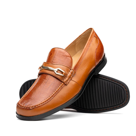 The Marco Di Milano Ravello Honey is a brown leather loafer with a textured finish and metal detail, displayed upright and on its side to show the rubber sole—ideal for those seeking luxury footwear.