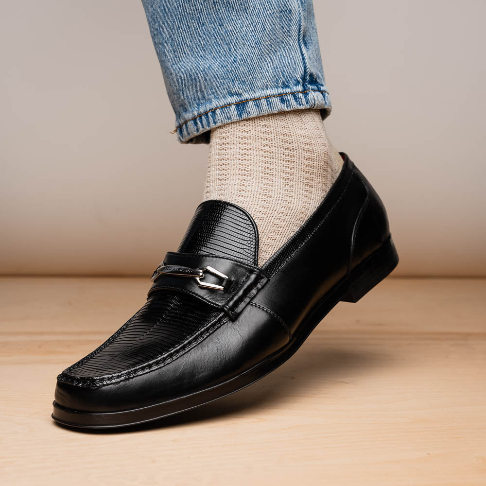 The Ravello Black by Marco Di Milano is a pair of black leather loafers with metal accents, textured uppers, a red interior lining, and ribbed rubber soles—making an exquisite statement in luxury footwear.